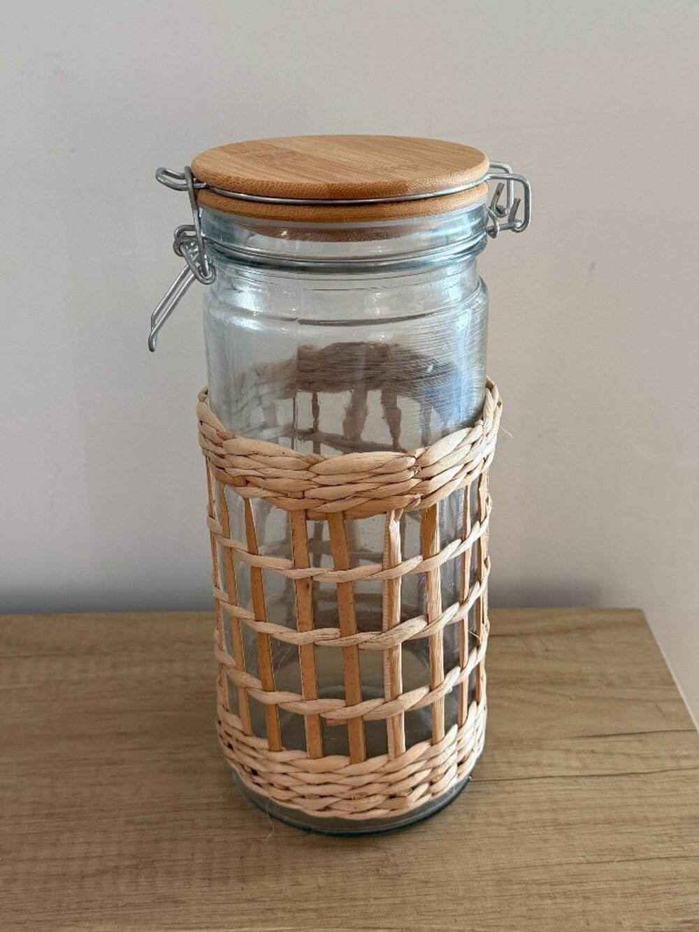 glass storage jar with bamboo lid and rattan sleeve 10"